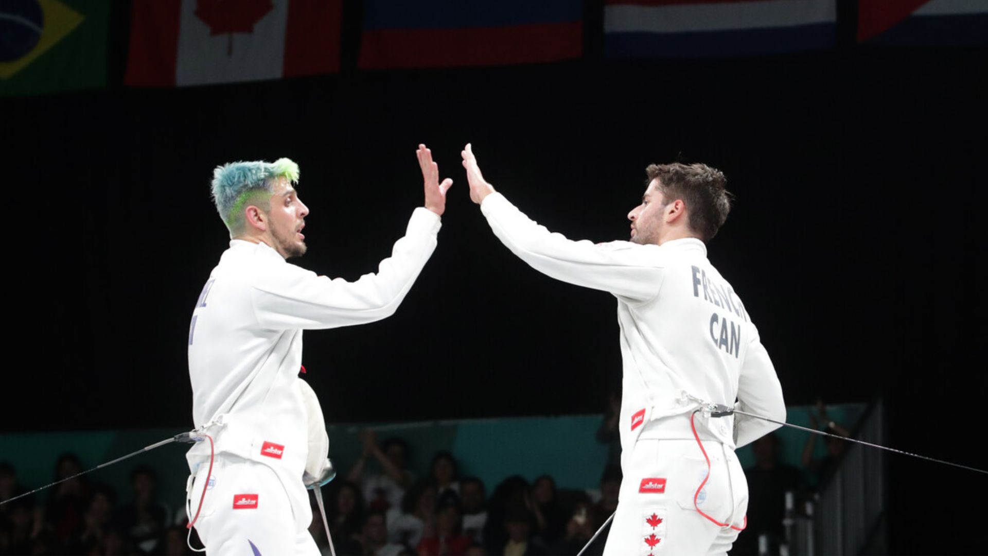 The United States and Canada celebrate with gold in the beginning of fencing
